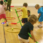 Sportball kids playing ball hockey in gym