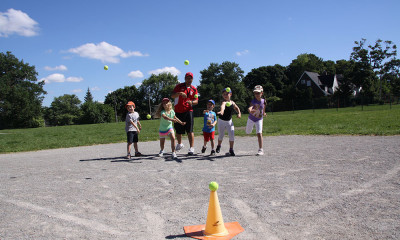 Children playing outdoor baseball.