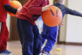 Child bouncing basketball.