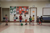 Children running to get basketball.