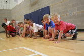 Smiling children ready to race during Sportball multi-sport class.
