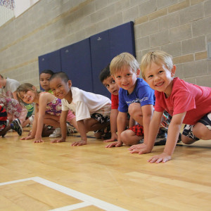 Smiling children ready to race during Sportball multi-sport class.