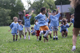 Sportball kids jumping for joy during Soccer class.