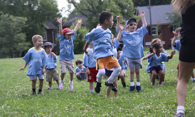 Sportball kids jumping for joy during Soccer class.