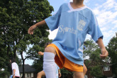 Happy boy showing soccer skills during Sportball soccer class.