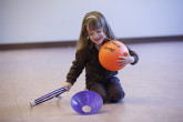 Girl smiling during Sportball tennis class.